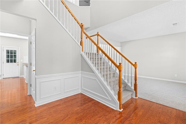 7000 Foxberry Ln, Roswell, GA 30075 - stairway with wood finished floors and a wainscoted wall