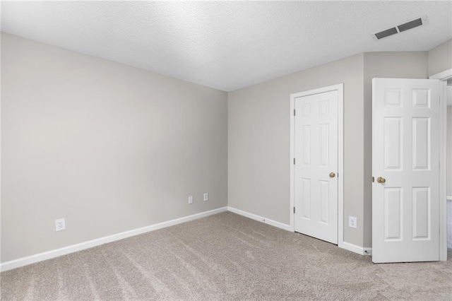 7000 Foxberry Ln, Roswell, GA 30075 - unfurnished bedroom featuring carpet flooring and a textured ceiling