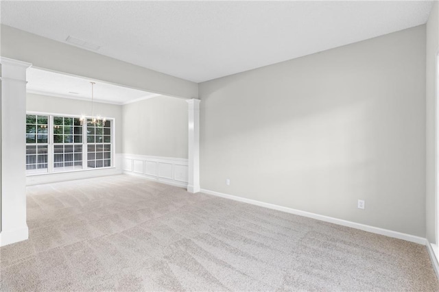7000 Foxberry Ln, Roswell, GA 30075 - carpeted spare room with a chandelier, ornate columns, wainscoting, and a decorative wall