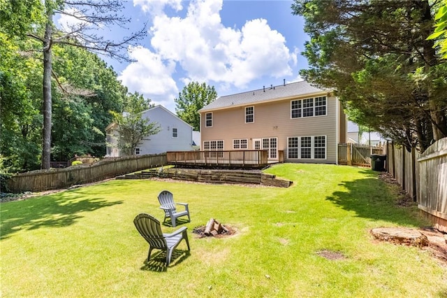 7000 Foxberry Ln, Roswell, GA 30075 - back of house with a fenced backyard, a wooden deck, and an outdoor fire pit
