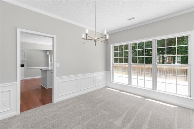7000 Foxberry Ln, Roswell, GA 30075 - unfurnished dining area featuring carpet floors, a textured ceiling, a chandelier, a wainscoted wall, and crown molding