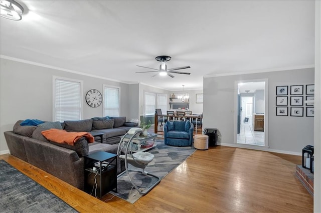 living room featuring hardwood / wood-style floors, ceiling fan, and crown molding