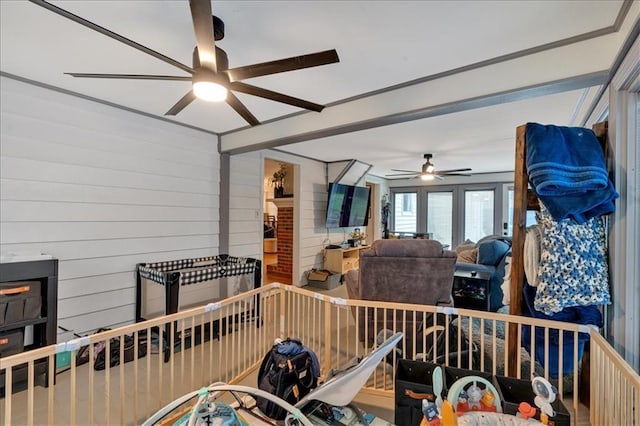 interior space with wood walls and ceiling fan