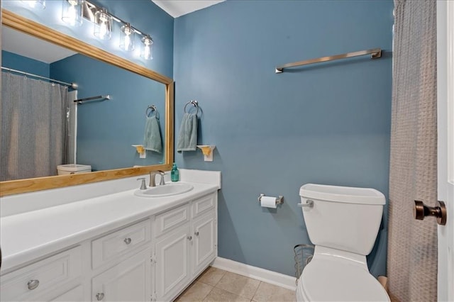 bathroom featuring tile patterned flooring, vanity, and toilet