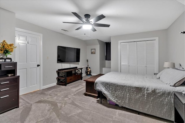 bedroom featuring ceiling fan, light colored carpet, and a closet