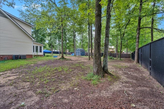 view of yard with a storage unit and cooling unit