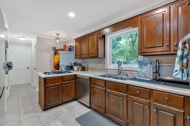 kitchen featuring sink, stainless steel appliances, kitchen peninsula, pendant lighting, and ornamental molding