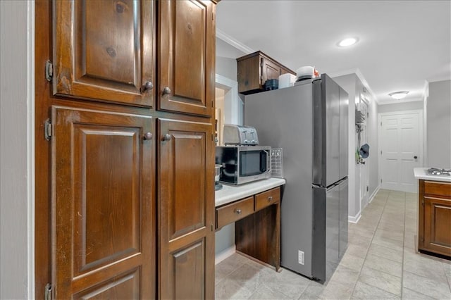 kitchen featuring stainless steel appliances and crown molding