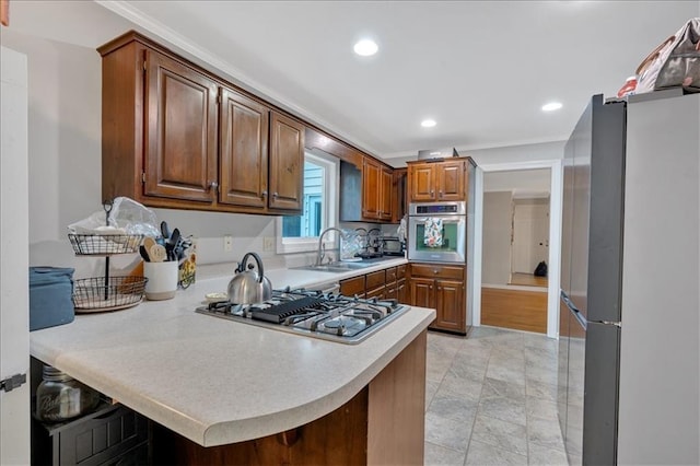 kitchen with a breakfast bar, sink, kitchen peninsula, and stainless steel appliances