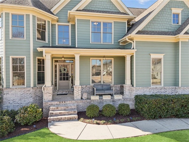 property entrance with brick siding and roof with shingles