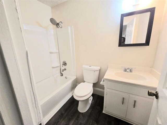 full bath with wood finished floors, toilet, vanity, and shower / tub combination