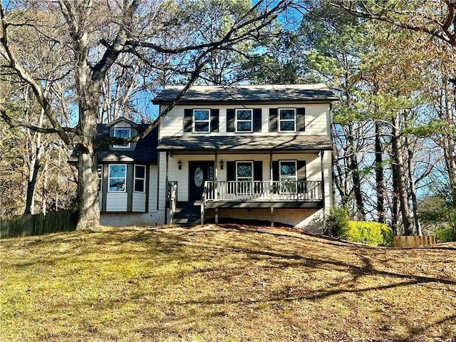 view of front property featuring covered porch and a front yard