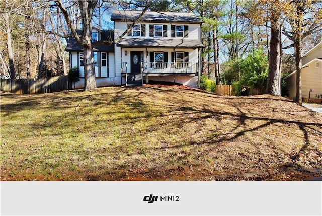 view of front of property with covered porch and a front yard