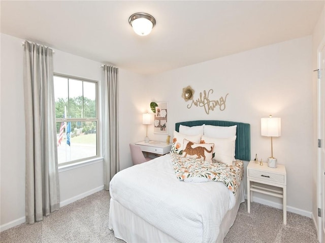 bedroom with baseboards and carpet flooring