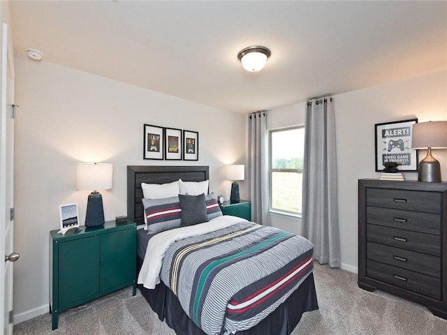 bedroom featuring carpet flooring and baseboards