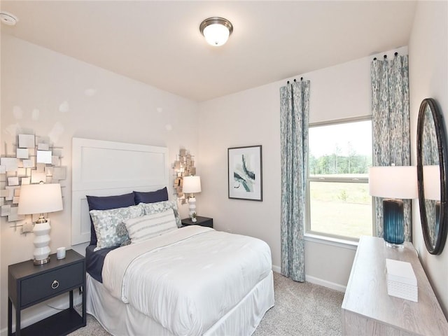 carpeted bedroom featuring baseboards