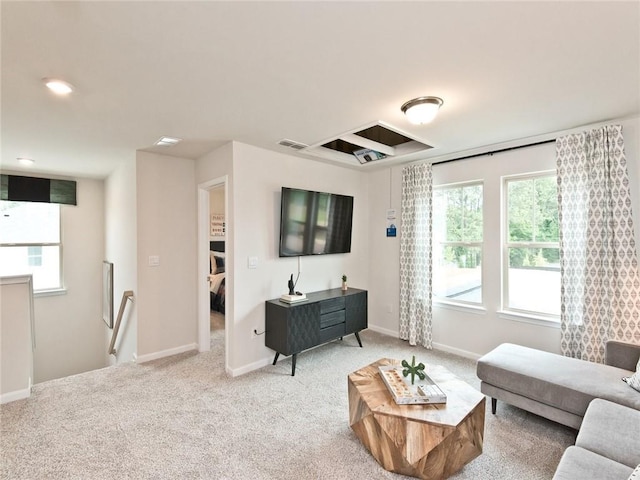 carpeted living area featuring visible vents, plenty of natural light, and baseboards