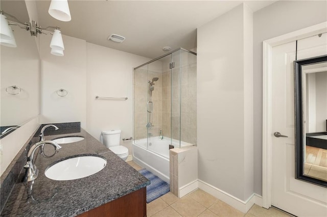 44 Peachtree Pl NE Unit 1824, Atlanta, GA 30309 - full bath with tile patterned flooring, toilet, combined bath / shower with glass door, double vanity, and baseboards