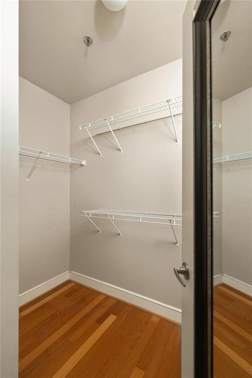 44 Peachtree Pl NE Unit 1824, Atlanta, GA 30309 - walk in closet featuring wood finished floors