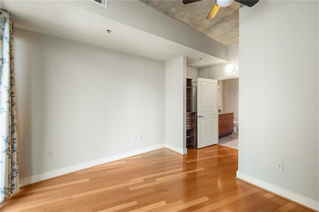 44 Peachtree Pl NE Unit 1824, Atlanta, GA 30309 - spare room with light wood-style floors, ceiling fan, and baseboards
