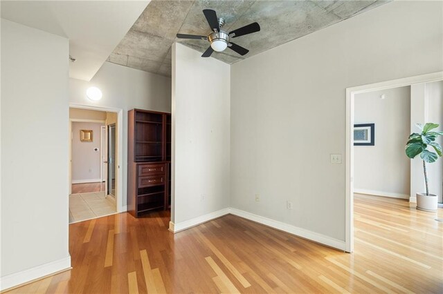 44 Peachtree Pl NE Unit 1824, Atlanta, GA 30309 - spare room with wood finished floors, a ceiling fan, and baseboards