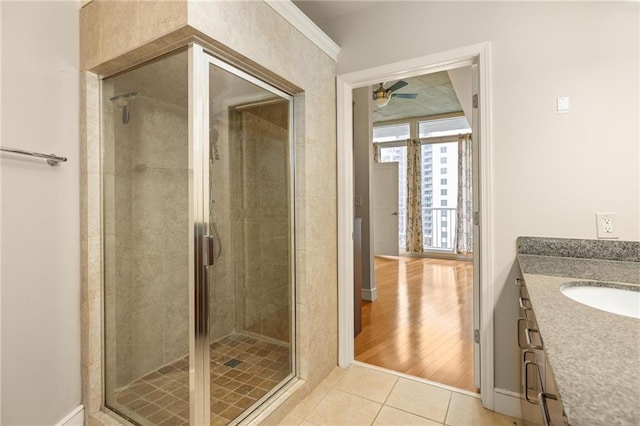 44 Peachtree Pl NE Unit 1824, Atlanta, GA 30309 - full bathroom featuring ceiling fan, vanity, tile patterned flooring, a shower stall, and baseboards