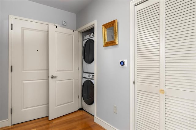 44 Peachtree Pl NE Unit 1824, Atlanta, GA 30309 - laundry area with stacked washer and clothes dryer and light wood-style floors