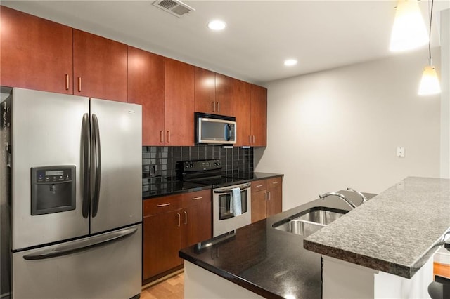 44 Peachtree Pl NE Unit 1824, Atlanta, GA 30309 - kitchen with appliances with stainless steel finishes, a sink, dark countertops, a peninsula, and backsplash