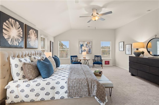 bedroom featuring a ceiling fan, light colored carpet, vaulted ceiling, and baseboards