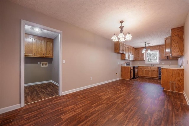 kitchen featuring electric range, baseboards, dark wood finished floors, and a textured ceiling