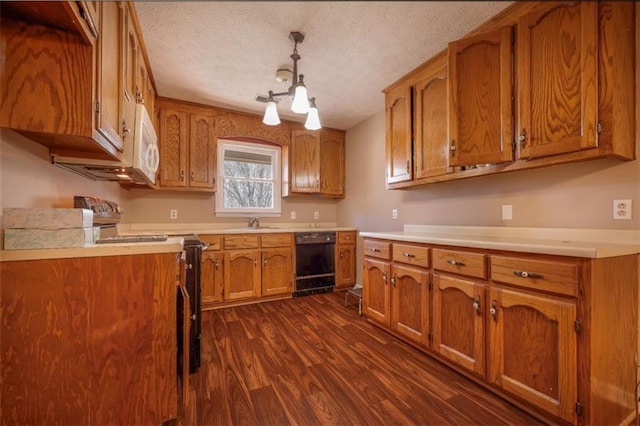 kitchen featuring dark wood-style flooring, white microwave, brown cabinetry, stainless steel range with electric stovetop, and dishwasher