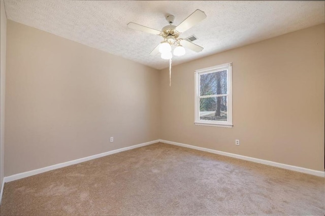 unfurnished room with baseboards, visible vents, light colored carpet, ceiling fan, and a textured ceiling