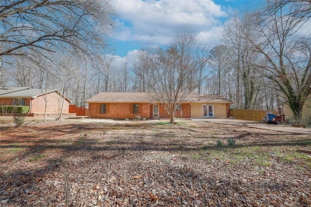 ranch-style home with fence