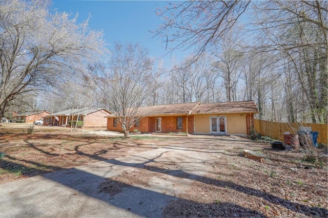 single story home featuring fence