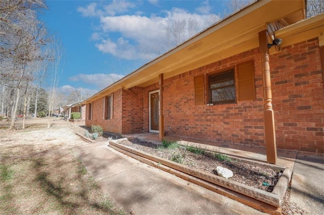 view of property exterior with brick siding