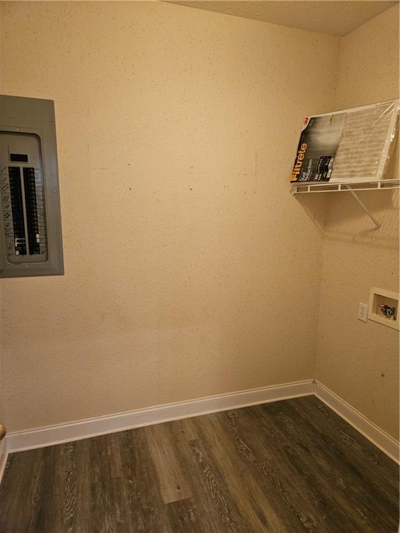 clothes washing area with laundry area, dark wood-type flooring, washer hookup, and electric panel