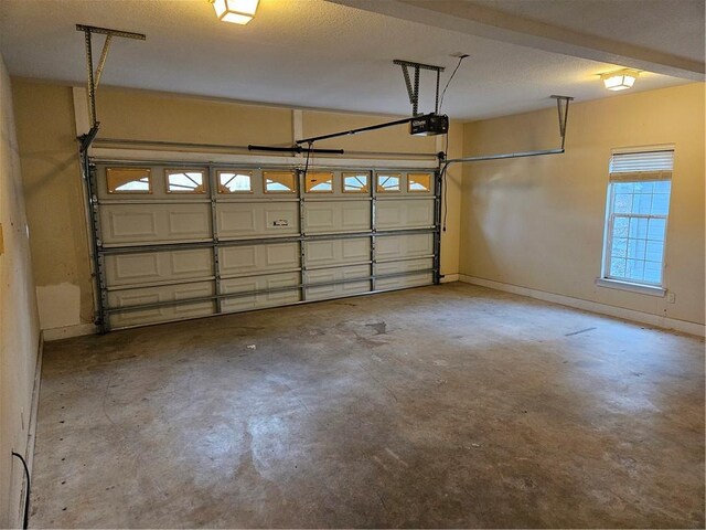 garage with baseboards and a garage door opener