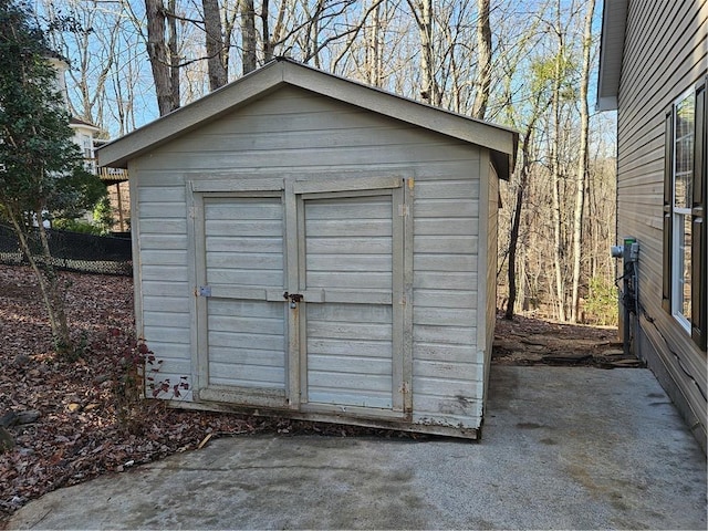 view of shed with fence