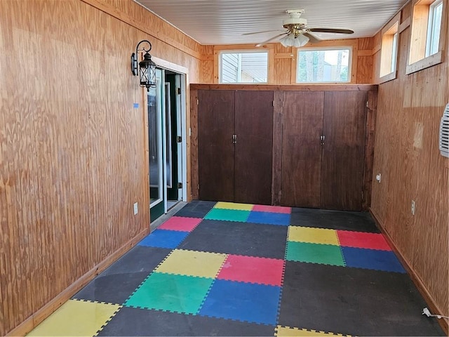 interior space with ceiling fan