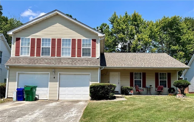 view of front of home featuring a garage, a front lawn, and covered porch