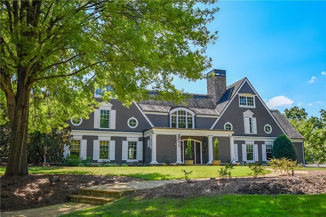 exterior space with a lawn and a chimney