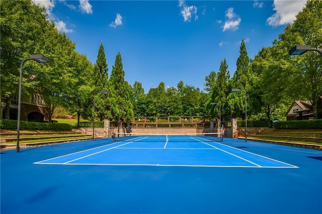 view of tennis court with fence