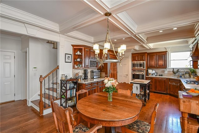 dining area featuring stairway, beamed ceiling, an inviting chandelier, and coffered ceiling