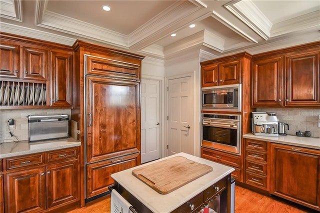 kitchen with light wood-type flooring, stainless steel appliances, and light countertops