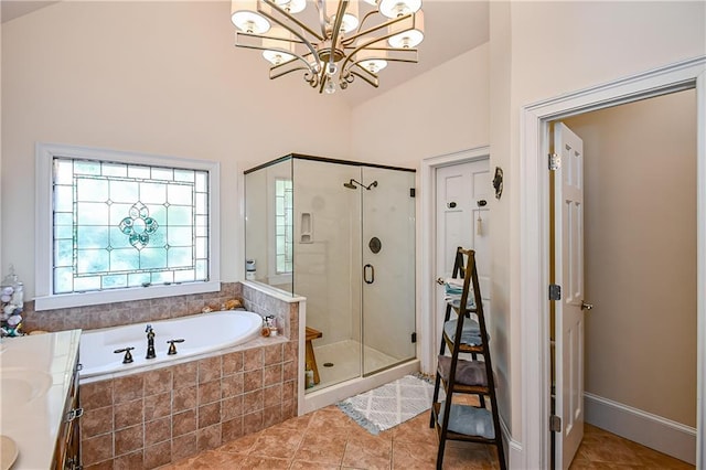 full bathroom featuring tile patterned flooring, an inviting chandelier, double vanity, a bath, and a shower stall