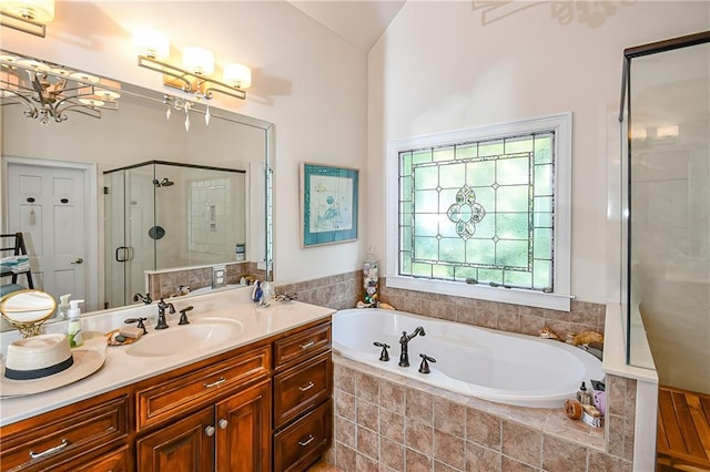 full bath featuring a garden tub, a stall shower, and vanity