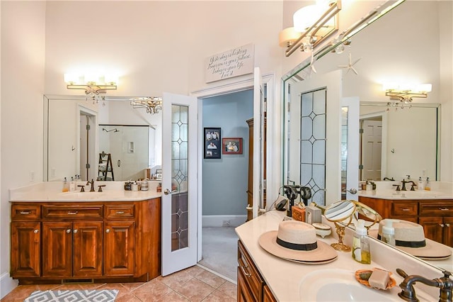 bathroom featuring tile patterned floors, a sink, and a chandelier