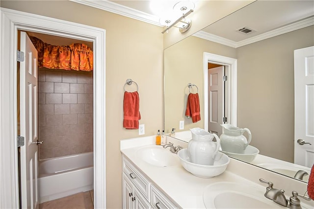 full bath featuring crown molding, visible vents, double vanity, and a sink