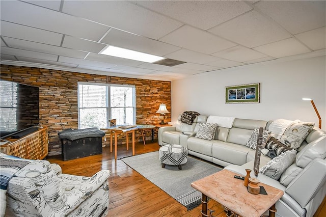 living room featuring wood finished floors and a drop ceiling