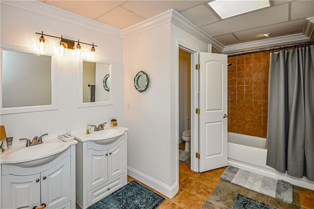 bathroom with shower / tub combo, toilet, crown molding, two vanities, and a sink